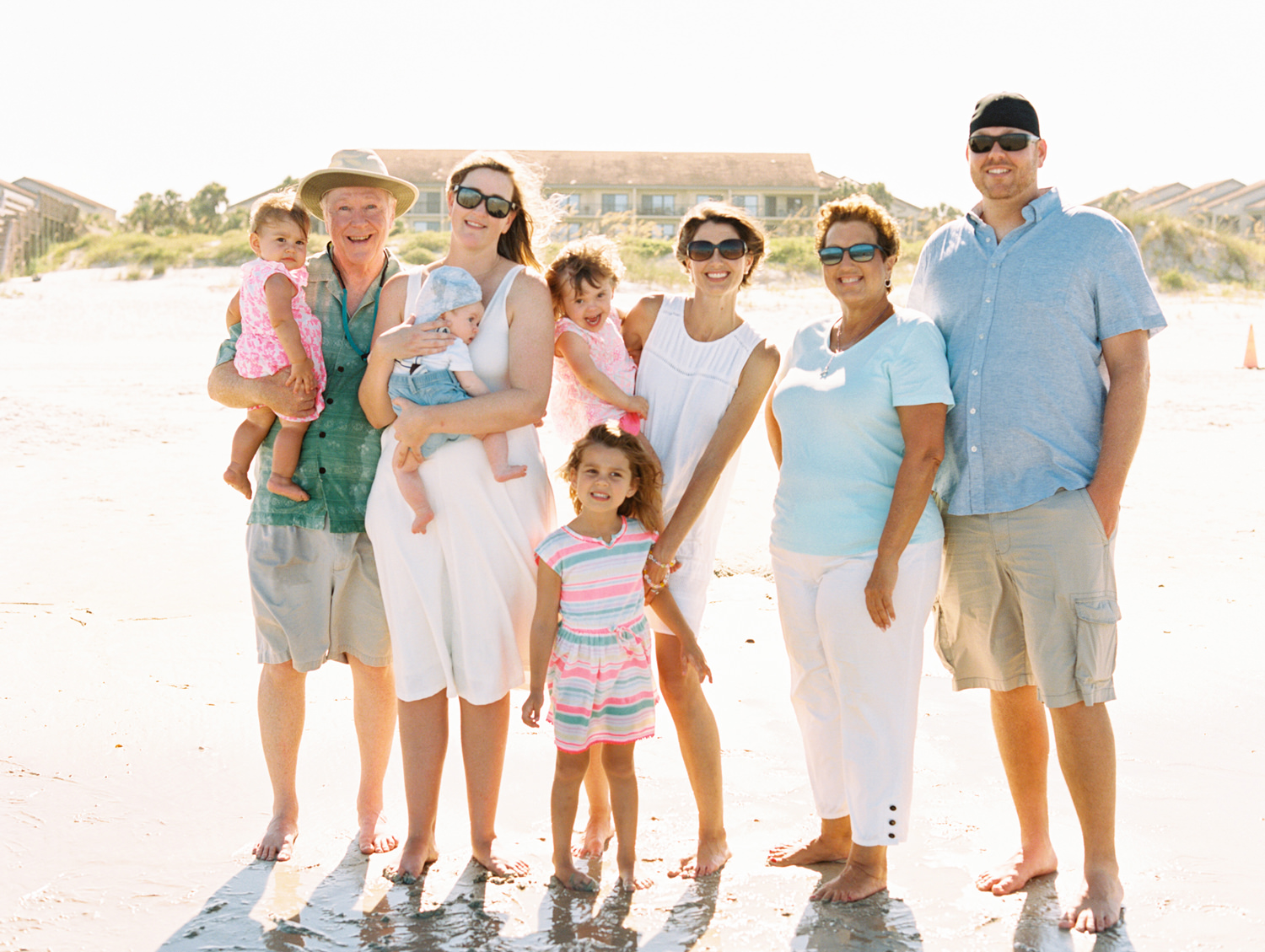 large extended family photo on a bright sunny beach