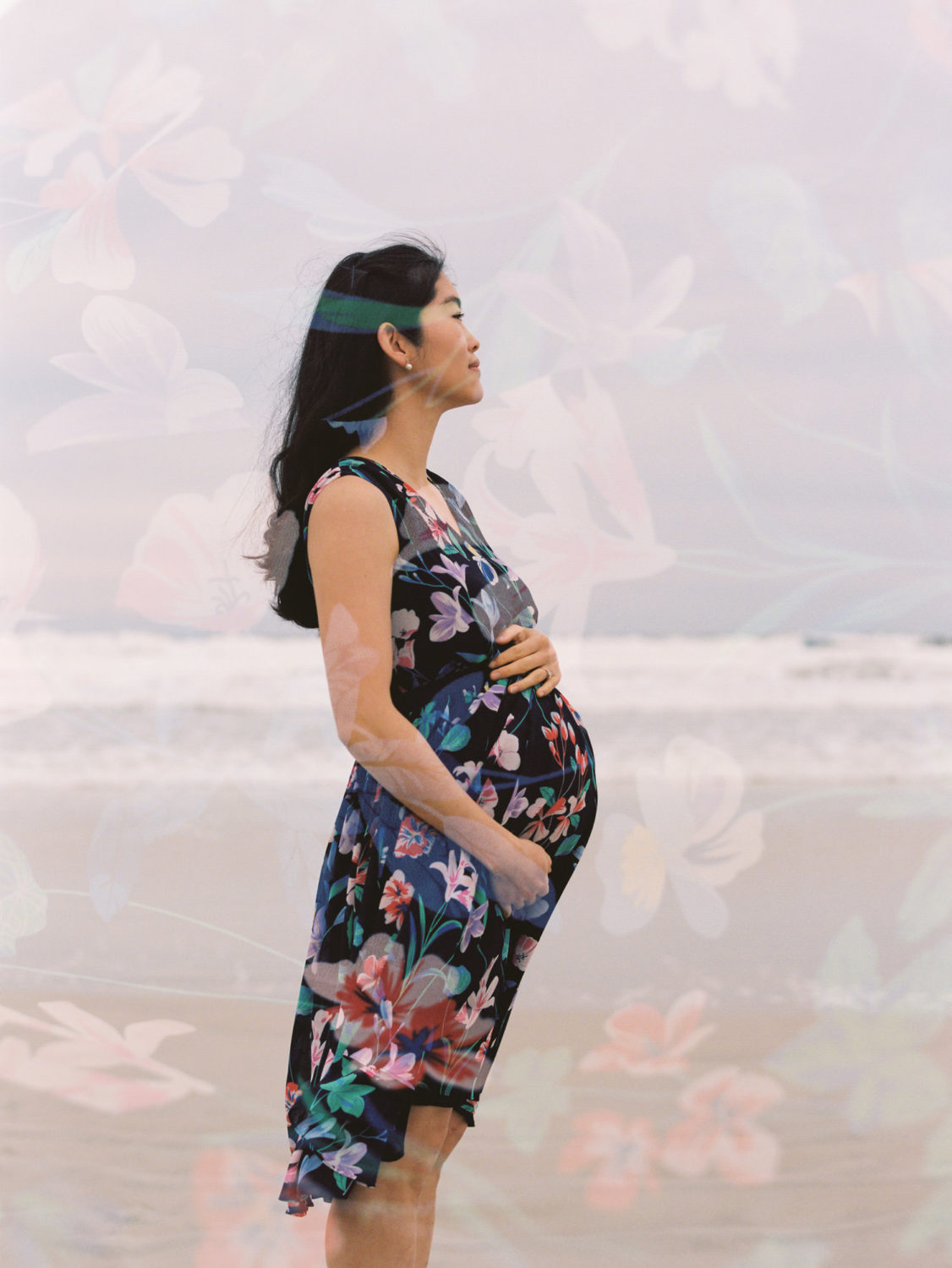 double exposure on color film of a pregnant asian woman in a floral dress at the beach with the dress pattern overlayed