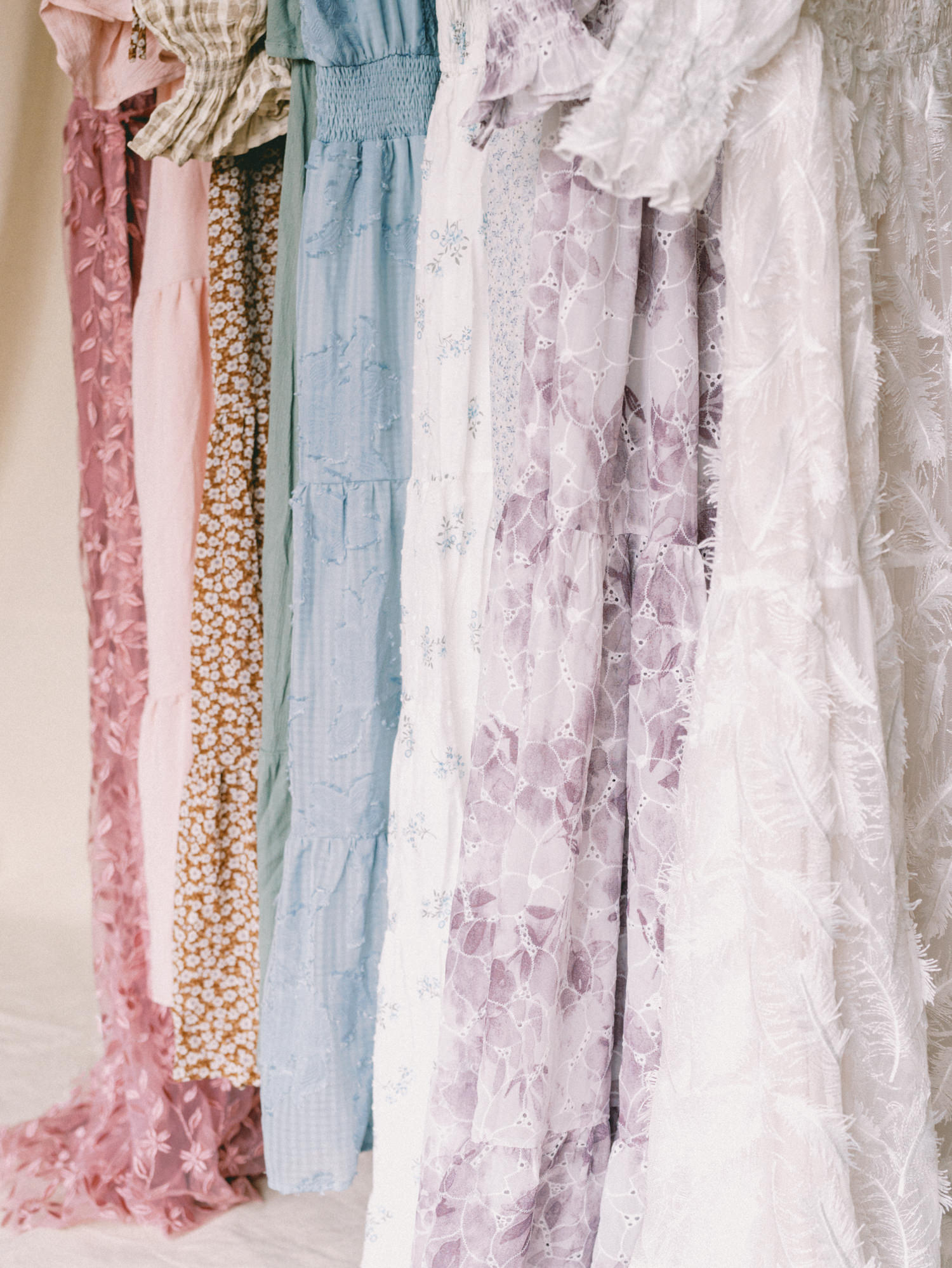 dresses hanging up from the client wardrobe of toronto maternity photographer emily anderson