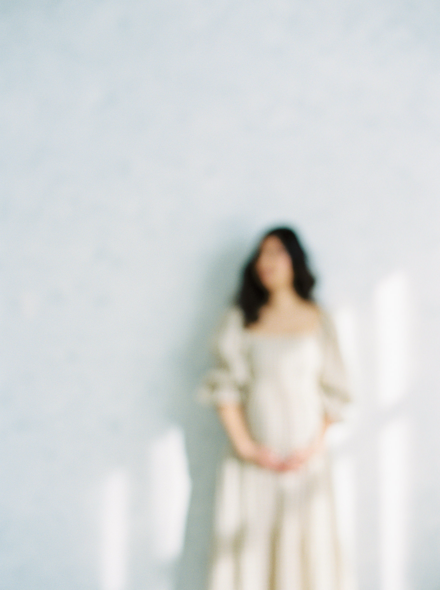 soft focused maternity image on film of a pregnant Markham woman with sunlight shining through the window.