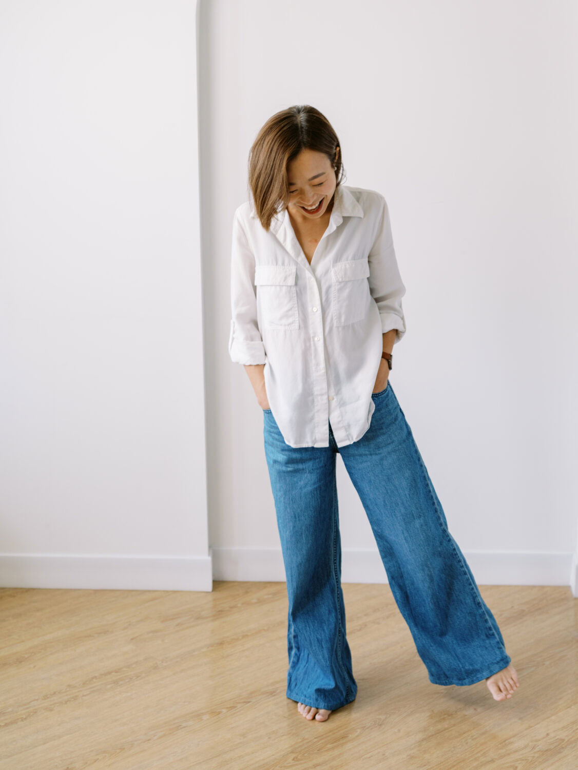 working mom with a bob haircut in white shirt and jeans at her brand photo session